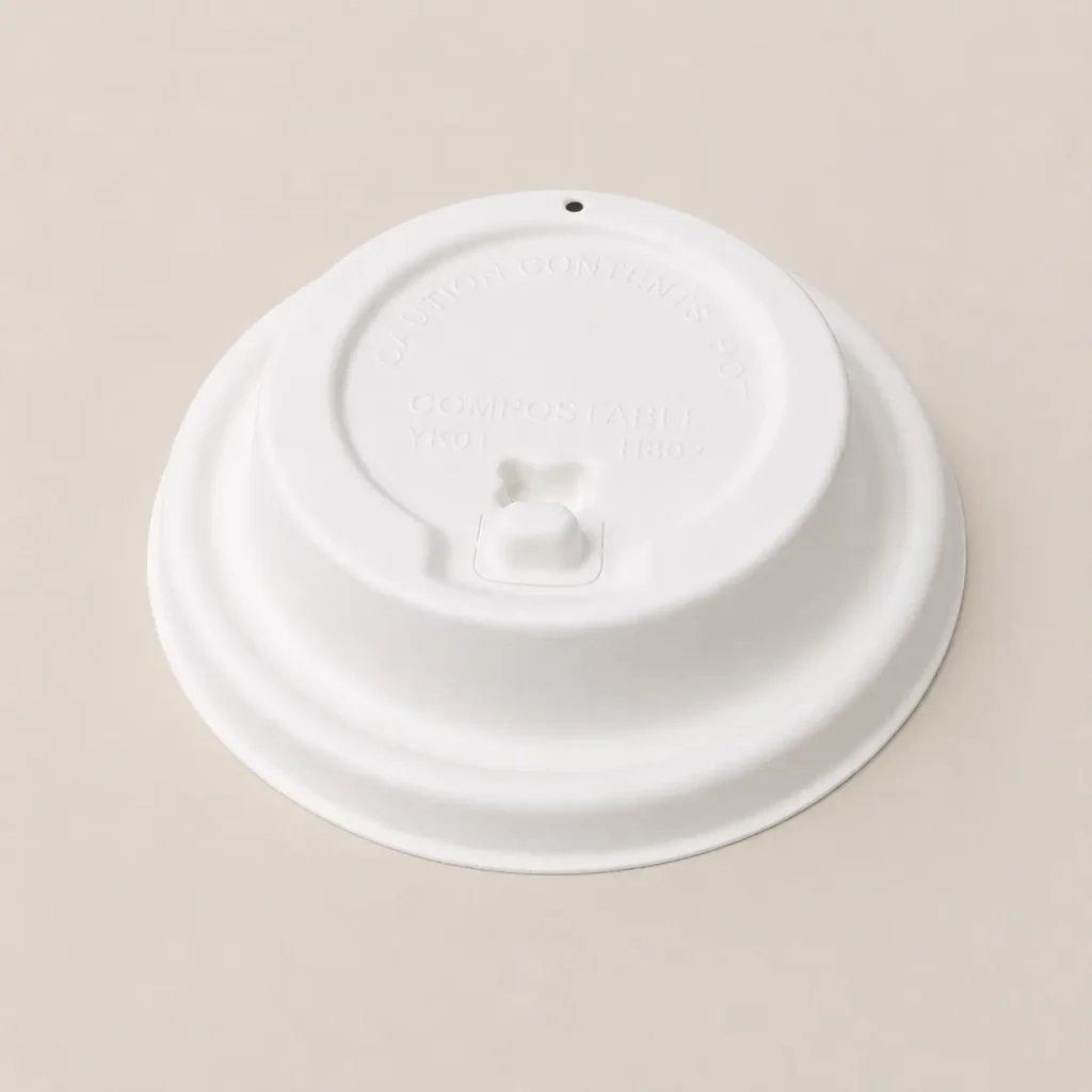 White 80mm flip-top molded fiber hot cup lid with the hinged drinking tab in the closed position